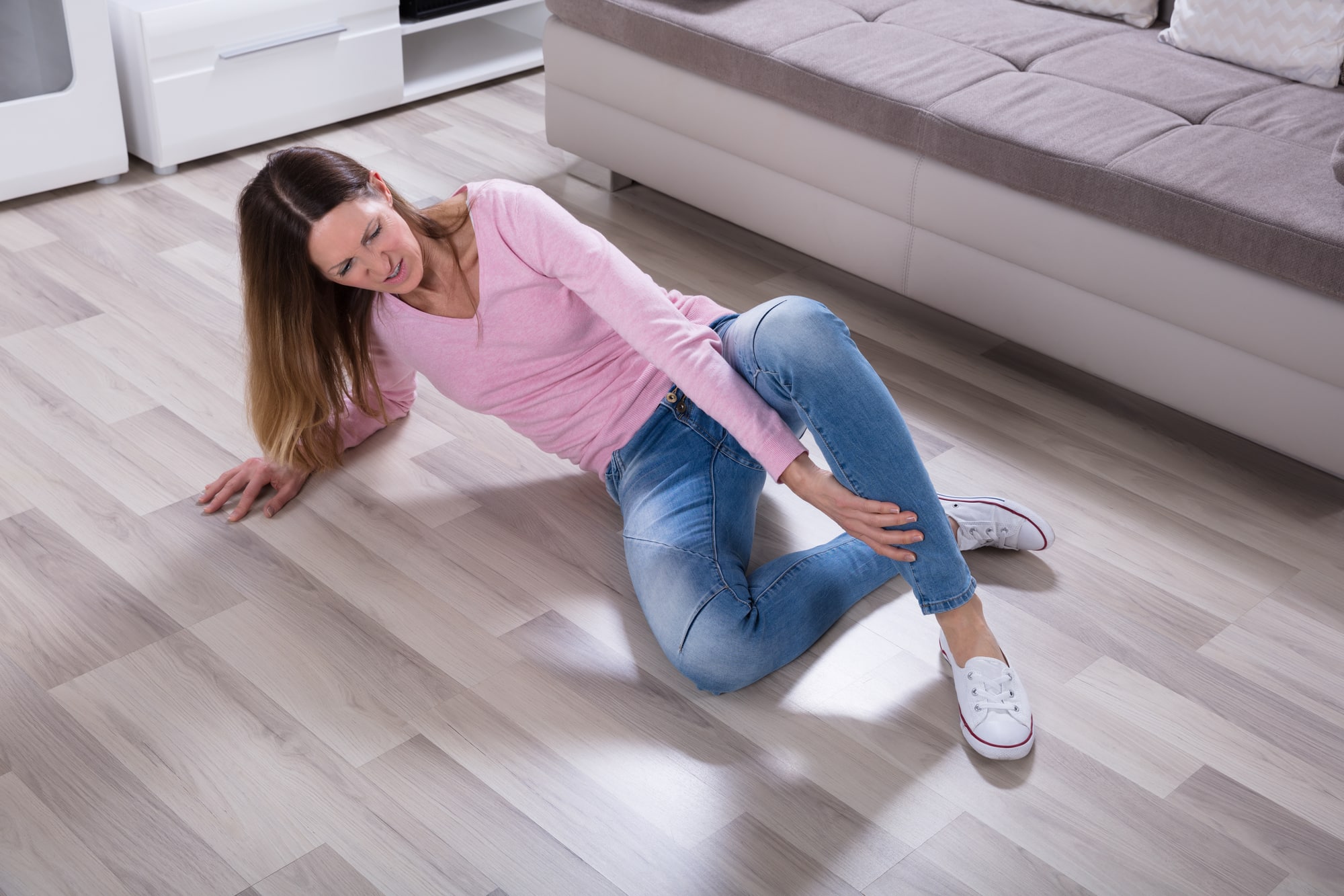 Woman Falling On Floor Having A Leg Pain